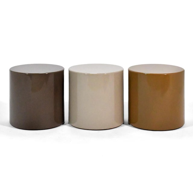 These minimalist, cylindrical tables by Metro are finished in a beautiful muted palate of Gray, Taupe and Cider Brown....