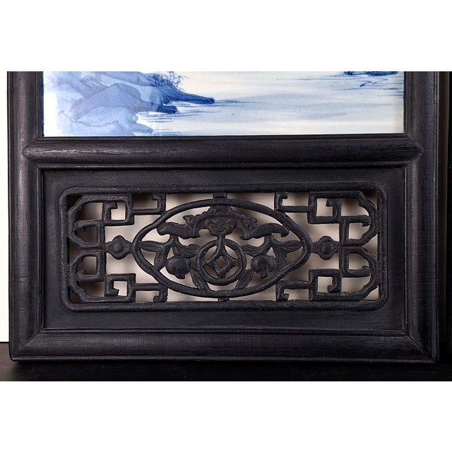 A pair of Chinese porcelain landscape plaques, with finely painted landscapes in blue and white glazes of river and...