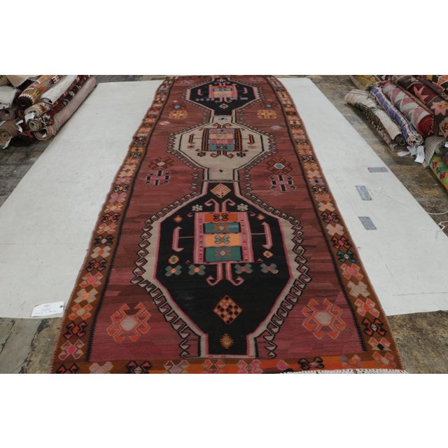 A mid-century vintage tribal kilim, this piece originated in Turkey, hand woven between 1950-1960. The vintage Turkish...