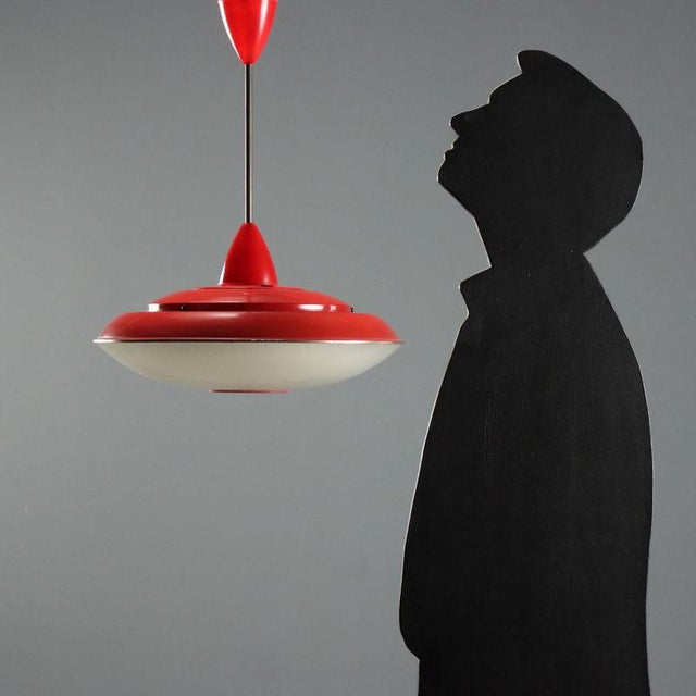 1960s pendant chandelier made of enameled aluminum and glass. The design features an aluminum structure with a red...