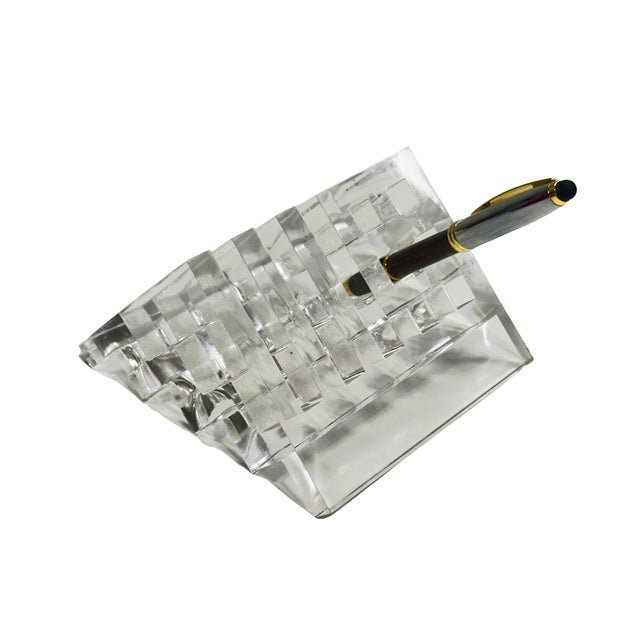 A sculptural vintage clear Lucite desk organizer and stationery holder featuring a dramatic repeating wave construction....