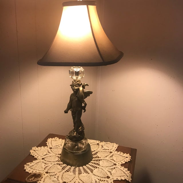 This is an absolutely stunning mid century cherub lamp made of metal (I am almost positive it is bronze but could be...