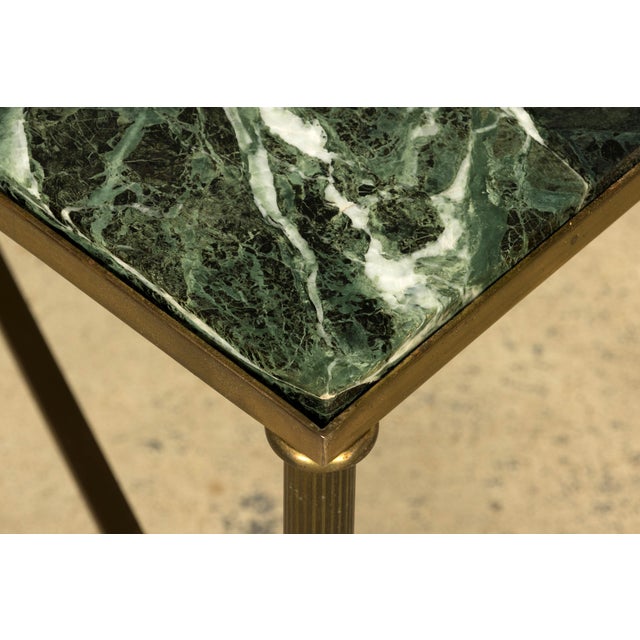 A refined mid-20th century French Maison Jansen style brass and green marble coffee table, sourced in Provence, France....