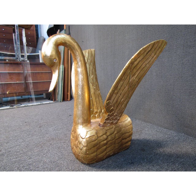 This unique swan table sculpture features an elegant design using gold leaf. WEAR Some scratches, nicks, and scuffs. Wings...