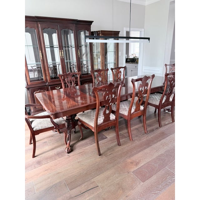 A complete formal dining suite in dark mahogany: large pedestal dining table with full set of extension leaves, and 8...
