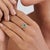 This Art Deco-style halo ring features a 0.74 ct emerald cut emerald, set in 14k yellow gold. The emerald measures 6 × 4...