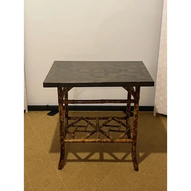 Beautiful burnt bamboo side table with a new top. The base is so unusual with a very intricate shelf. The original top was...