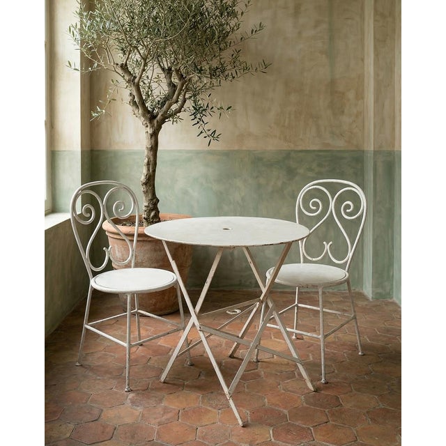 Charming and practical early 20th-century French folding metal round garden table. Featuring a beautifully patinated iron...