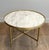 This beautiful round neoclassical-style coffee table is made of brass with a white Carrara marble top. It is a French work...