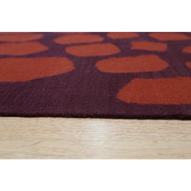 This flat weave wool rug features a primary color palette of yellow, gold, and orange tones. Woven in China, this Kilim...