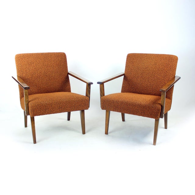 Elegant pair of Czechoslovak armchairs produced by Tatra in the 1960s. Featuring sculptural oak frames with dark stained...