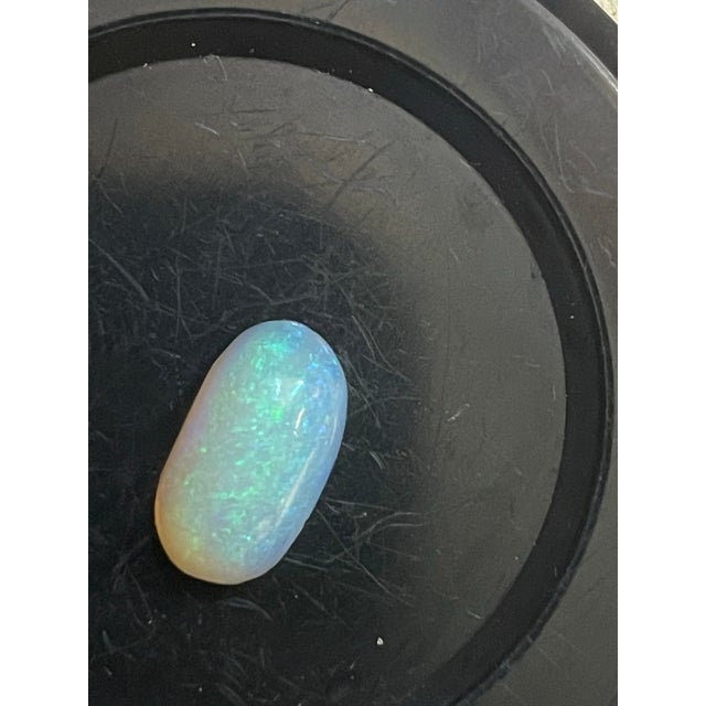 This exquisite 2 carat Australian jelly opal captures a mesmerizing, dreamlike elegance with its remarkable clarity and...