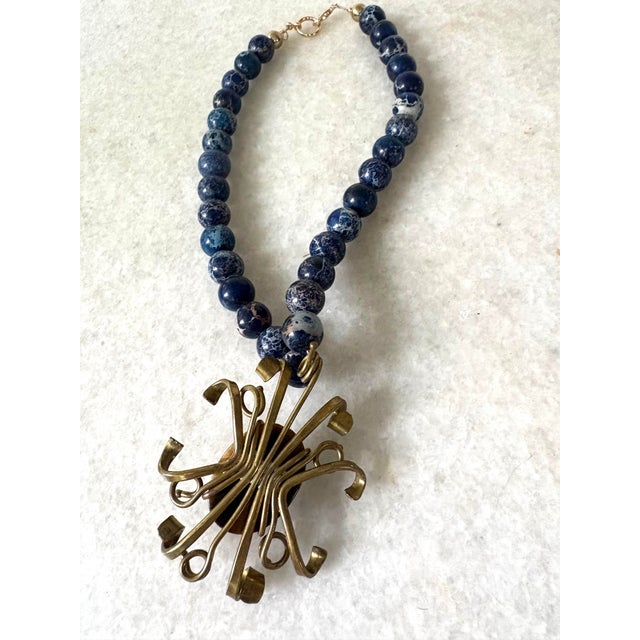 Stunning lapis beaded necklace with brass and Tiger’s eye pendant.