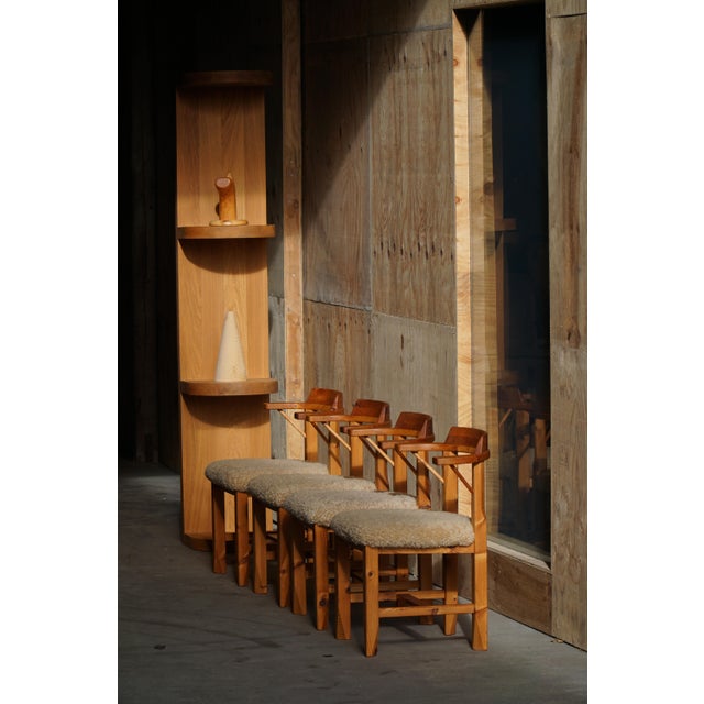 A charming set of four Danish dining chairs crafted in solid pine, dating from the 1970s. The chairs embody the warm,...