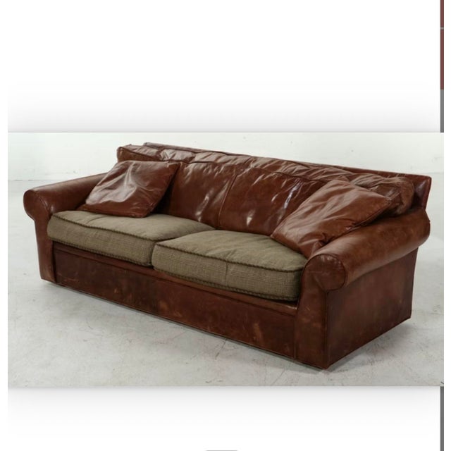 This expansive Ralph Lauren Home sofa embodies the quintessential English Country aesthetic, blending rugged masculinity...