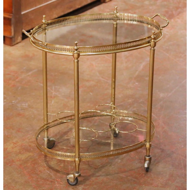 This elegant antique French bar cart was crafted circa 1950 and features a refined oval form with clean, neoclassical-...