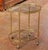 This elegant antique French bar cart was crafted circa 1950 and features a refined oval form with clean, neoclassical-...