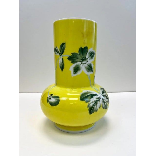 A beautiful hand painted porcelain vase. Rocking a vibrant yellow and decorated with flowers. A perfect piece for the Spring.