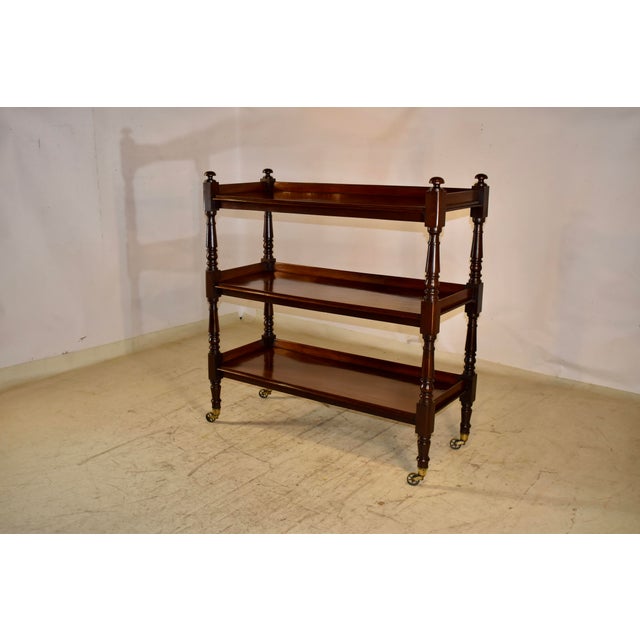 19th century mahogany dessert buffet from England. The top is adorned with hand turned finials over three shelves, all...