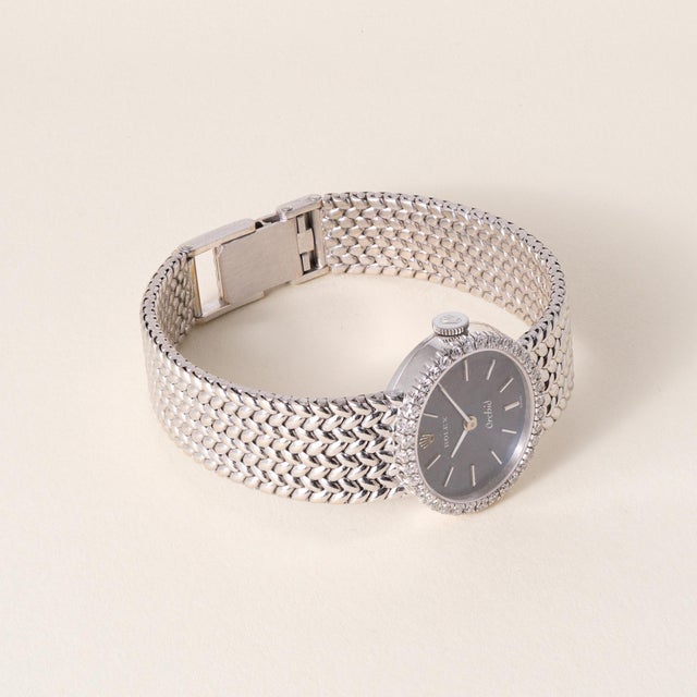 Vintage Rolex Orchid ladies’ cocktail watch in 18K white gold featuring a diamond bezel and blue dial with baton hour...