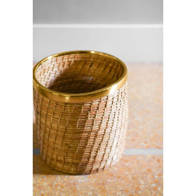 Wicker and brass vase holder, 1980s. Dimensions: 32 w x 32 h x 32 d cm Production: Italian production 1980 The vase holder...