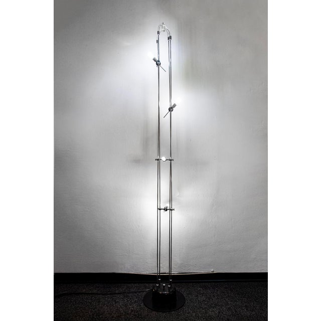 Floor lamp with a slender metal frame and acrylic glass details. Made in Italy 1980s European Plug (up to 250V).The wiring...