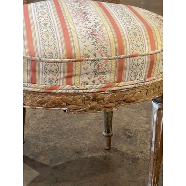 The Pair of French Louis XVI Giltwood Side Chairs is a luxurious and elegant addition to any home. These chairs are...