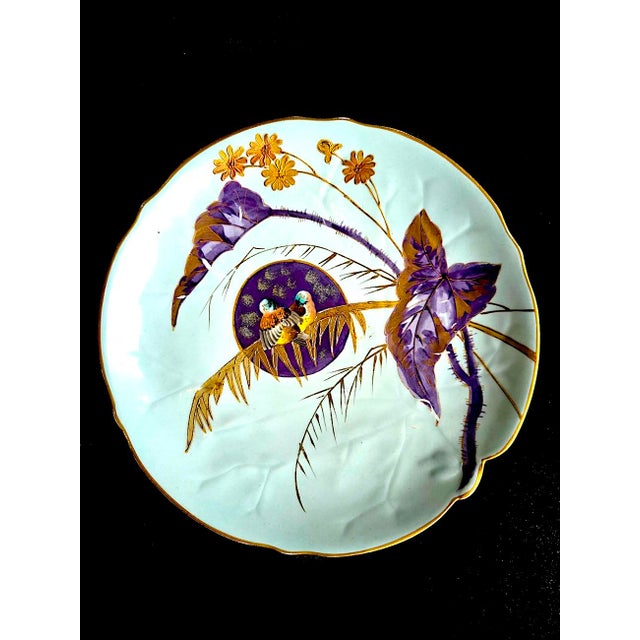 Offered is a hand-painted decorative porcelain plate with gold inlay leaves and scalloped rim made in the studio of...