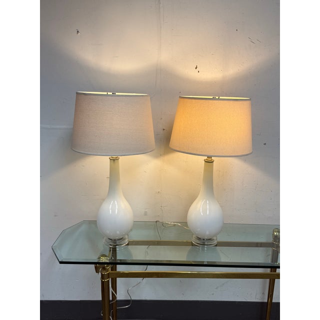 Design Plus Gallery presents a pair of Opaline Teardrop Table Lamps. The glossy glass bodies have rounded lower forms that...