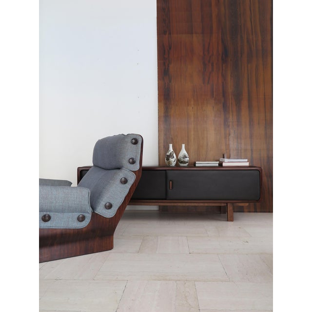 Scandinavian sideboard bench composed of 2 sliding doors with a solid wood structure covered in black leather on the top...