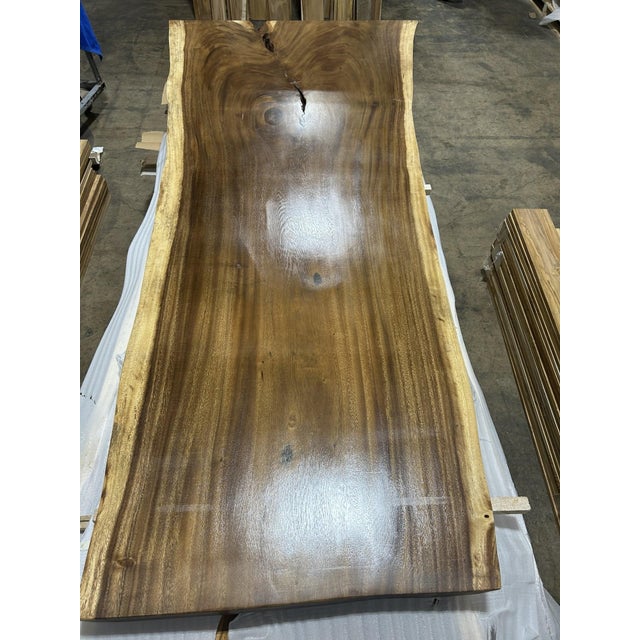 One tree. One top. One of one. A true single-slab live edge table: one continuous cross-section of a single Saman tree...