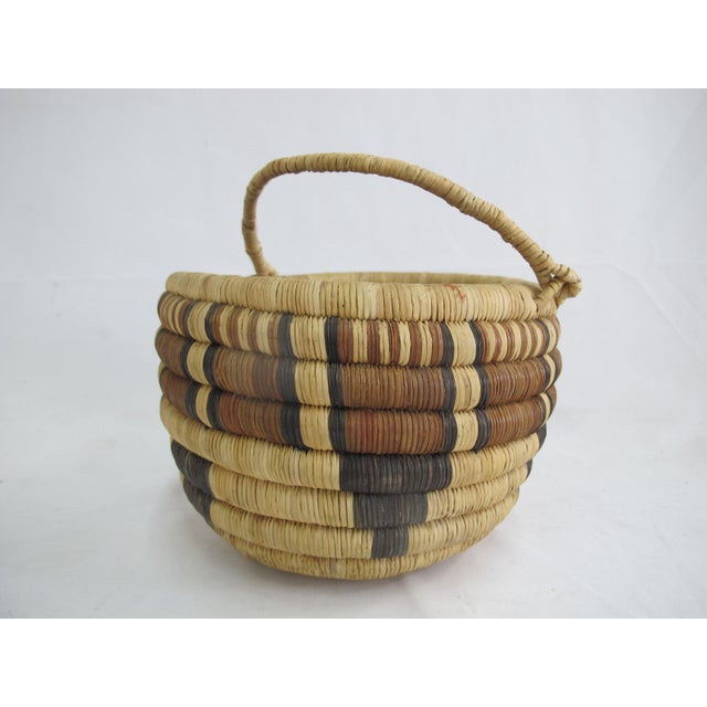 Vintage Hopi Native American woven basket with handle. Deep coiled basket with geometric design and handle. Measures 7...