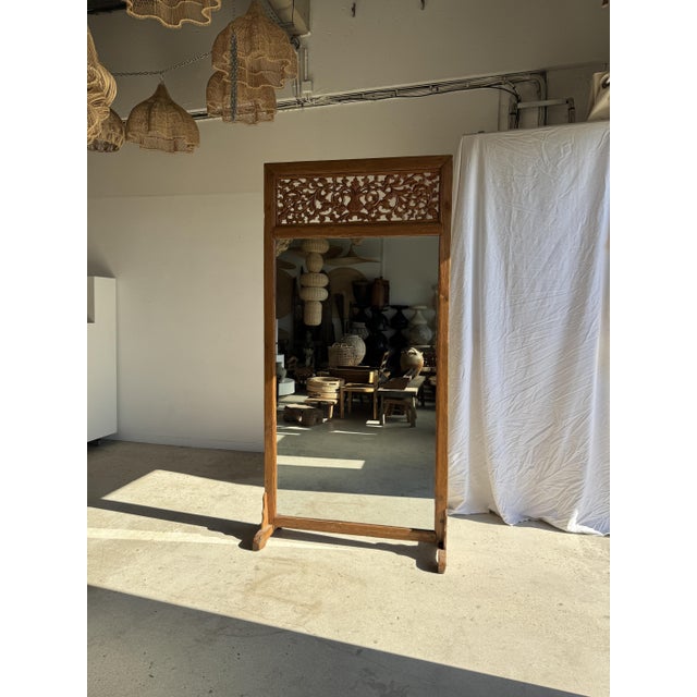 Very large freestanding teak mirror, of Indonesian origin. Rectangular frame in solid teak with a honey hue, visible...