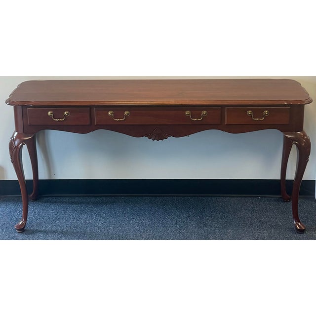 Elegant Ethan Allen Georgian Court console table crafted in rich cherry wood with a warm, polished finish. This classic...