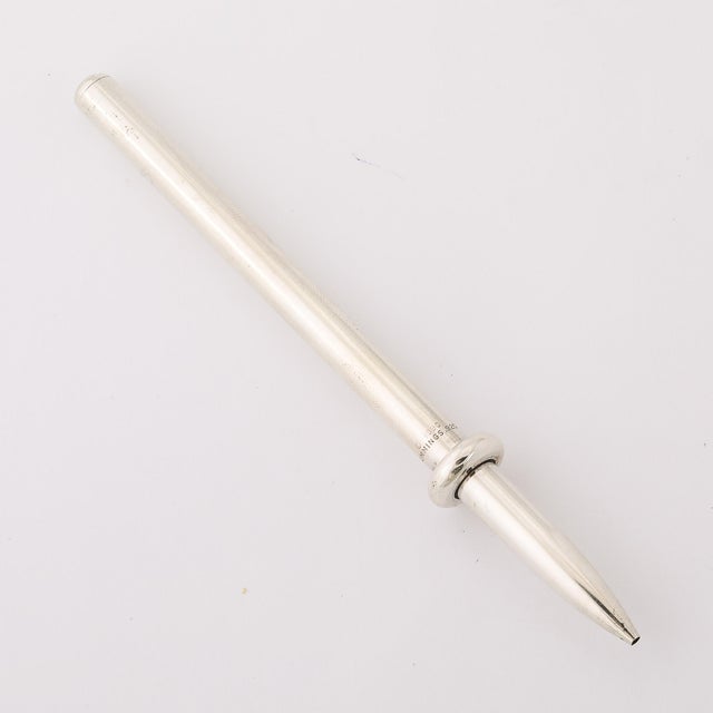 A sleek embodiment of refined minimalism, this Modernist Sterling Silver Ballpoint Pen, signed by Angela Cummings and...