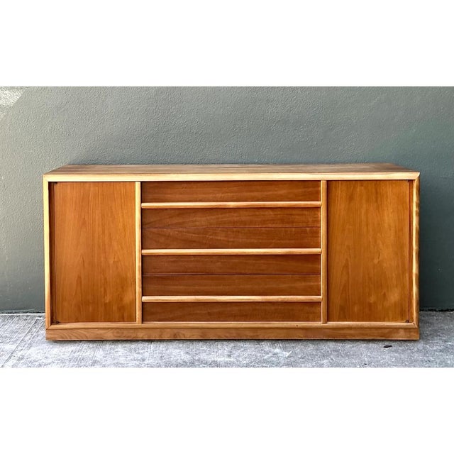 This T.H. Robsjohn-Gibbings for Widdicomb credenza exemplifies the designer's celebrated marriage of classical restraint...