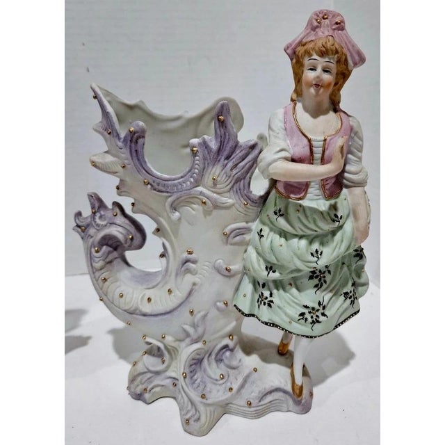 Add vintage elegance to your collection with this set of 2 Antique Paulux Occupied Japan Figurine Vases, featuring a...
