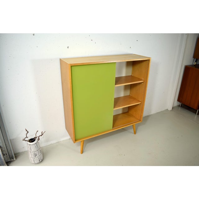 This piece is a bookcase with a glass sliding door from the renowned German company Hellerau. The bookcase was produced in...