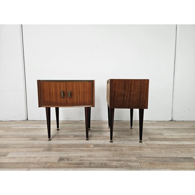 Elegant vintage bedside tables from the 1960s, featuring a refined mid-century design and beautiful walnut veneer...