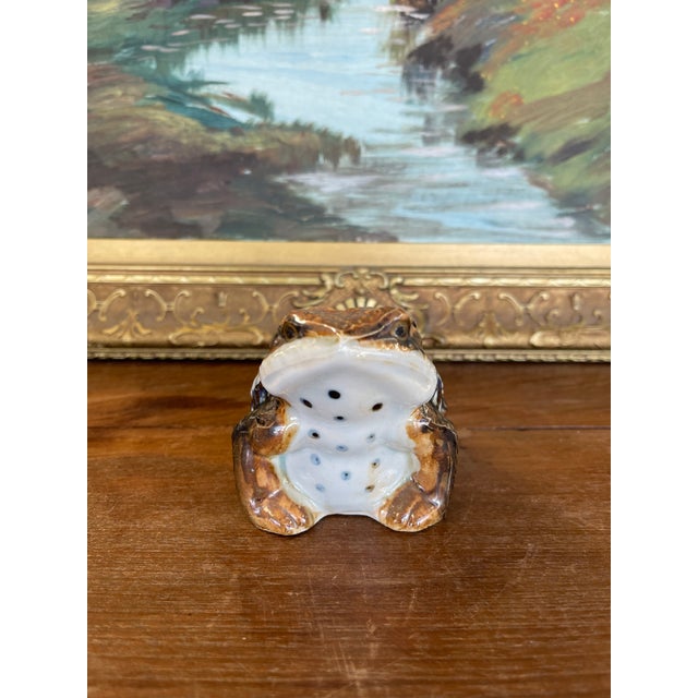 This likely antique Japanese ceramic toad sculpture dates to the Meiji period (circa late 19th to early 20th century) and...