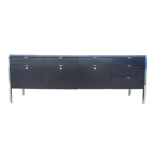 Stow Davis A vintage Stow Davis credenza with a leather top and chrome legs. This large storage unit has six small pencil...