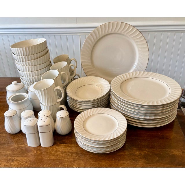 This elegant collection is characterized by its pristine white color and distinctive swirled patterns radiating from the...