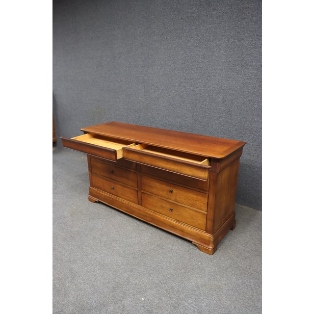 Louis Philippe style double dresser by National Mt. Airy, crafted in cherry with a warm, lightly distressed finish that...
