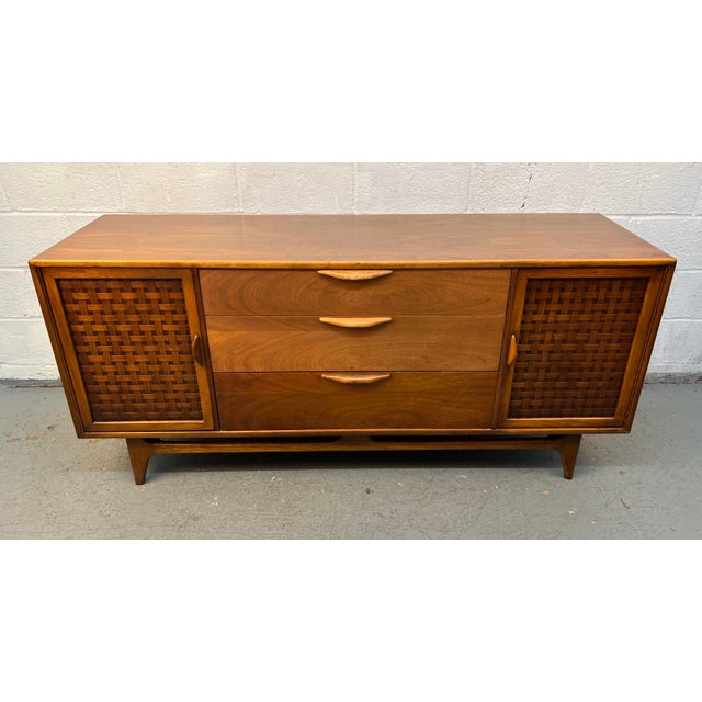 An iconic example of American mid-century modern design, this Lane "Perception" credenza, designed by renowned furniture...