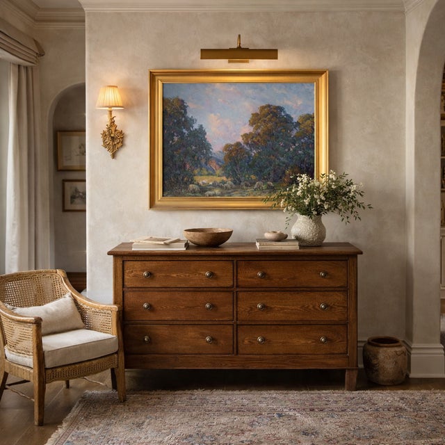 A peaceful landscape original oil painting features a countryside scene starring sheep at sunrise, with trees, a field,...