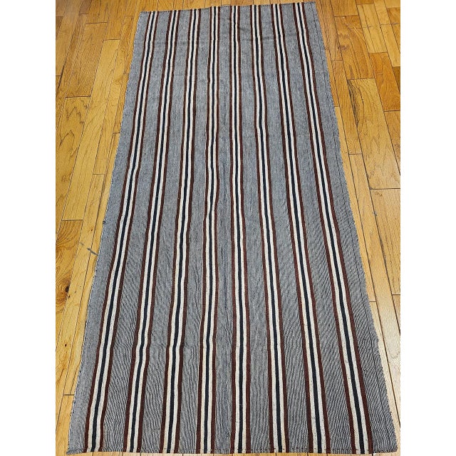 A study in understated Anatolian elegance, this vintage Turkish kilim from the third quarter of the 20th century features...