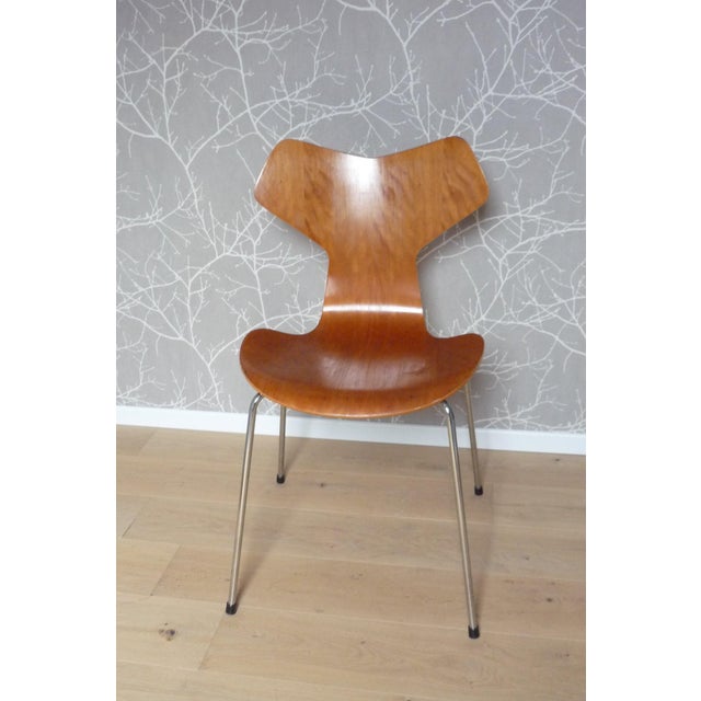 "Grand Prix" chair designed by Arne Jacobsen and produced by Fritz Hansen-Denmark. Teak shell and chrome base. The chair...