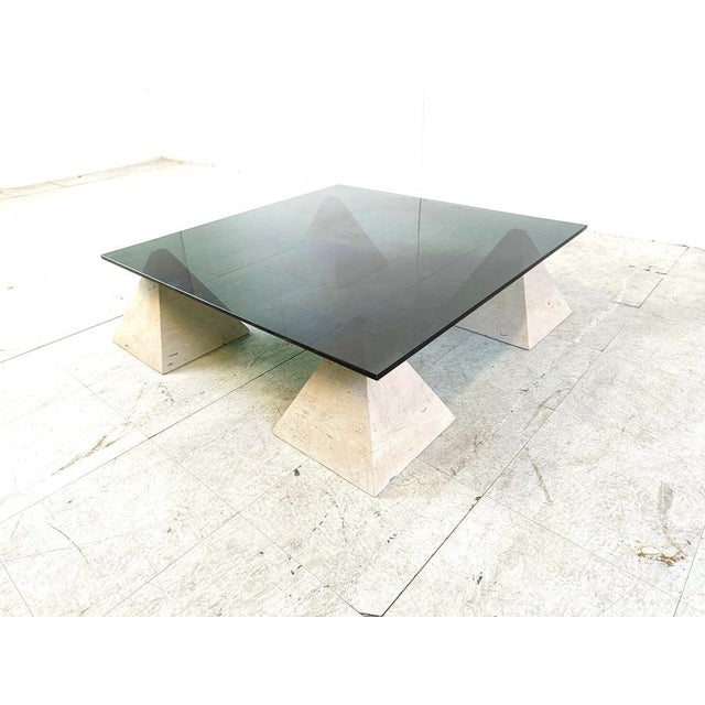 Vintage coffee table consisting of 4 stone pyramid shaped bases with a thick smoked glass top. Beautiful, timeless design....