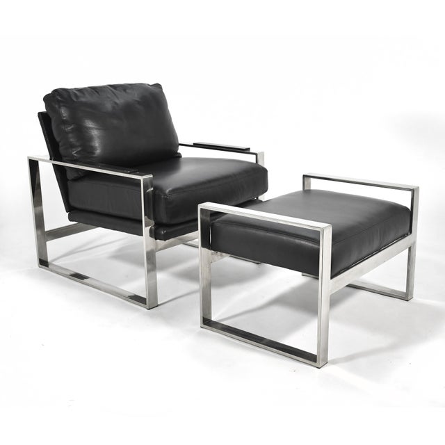 This refined lounge chair and ottoman has a architectural frame of chromed steel supporting a seat of rich black leather....