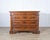 A refined 17th-century chest of drawers from central Italy, crafted in solid walnut and veneered with beautifully figured...